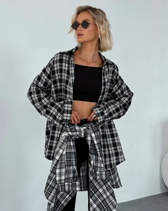 Detail of classic black and white plaid shirt showing cotton texture and loose long sleeves