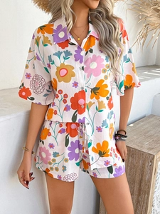 Detail of bohemian floral print shorts set with drawstring waist and button-down shirt