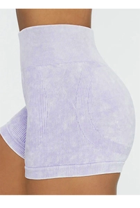 Close-up of acid-washed high-waisted yoga shorts in light purple with ribbed texture