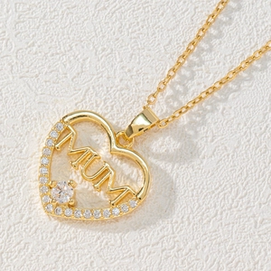 Macro shot of gold heart pendant necklace with MUM lettering and white zircons