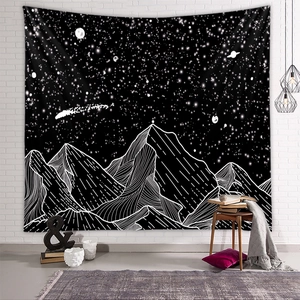 Detailed view of black and white mountain tapestry with starry night galaxy pattern