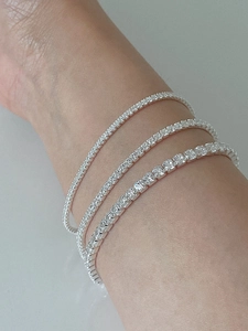 Three assorted sizes of 925 sterling silver tennis bracelets with white cubic zirconia