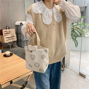 Corduroy tote bag in off-white with smiley face print used in a cafe setting