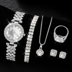 Close-up of 5-piece silver quartz watch set with rhinestones on black leather background