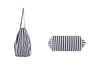 Detailed side and bottom view of a blue and white striped canvas tote bag with thick fabric