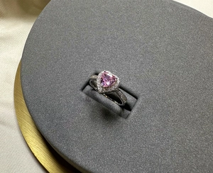 Macro detail of 925 silver heart-shaped pink diamond ring with sparkling halo setting