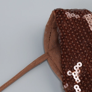 Macro shot of brown sequins on mesh fabric with detailed knitting craftsmanship