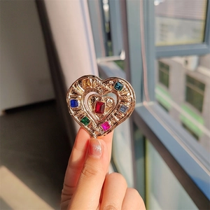 Vintage heart brooch in gold metal with colorful square crystals and luxury design