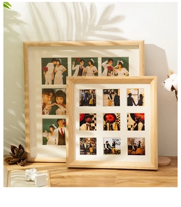 Detail of wooden 6 and 9-grid photo frames with white matting on a textured desk