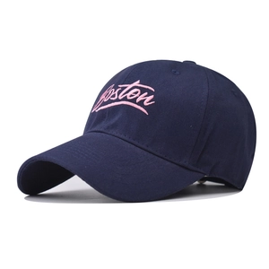 Close-up of pink Boston embroidery detail on a dark blue cotton twill baseball cap