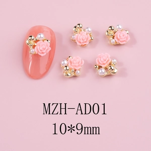 Macro shot of 10x9mm pink relief rose nail charms with gold base and white pearls