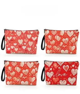 Detailed pattern display of four red heart-themed cosmetic bags with wrist straps