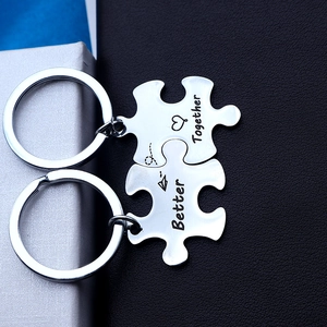 Close-up of interlocking puzzle keychains engraved with Better and Together words