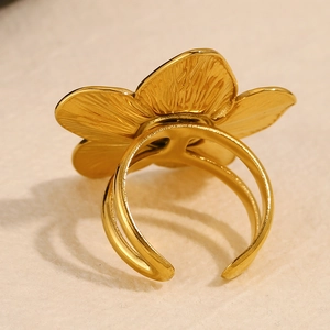 Detail view of the 18K gold plated flower ring showing petal texture and adjustable band
