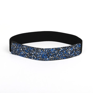 Close-up of sparkling blue and silver sequins on a flexible black elastic belt strap