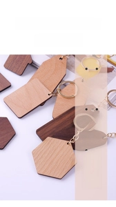 Detailed view of custom wood keychains in hexagon and house shapes with metal rings