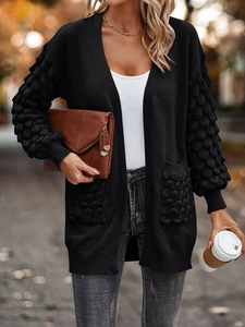 Detail of knit cardigan with bubble texture sleeves and ribbed cuffs in black