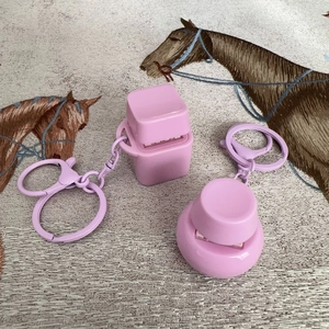 Pink square and round mechanical switch fidget toys with metal keyrings on fabric