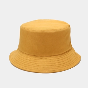 Detailed view of the yellow cotton bucket hat with clean stitching and reinforced brim