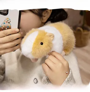 Close-up of a realistic brown and white plush guinea pig with soft faux fur texture