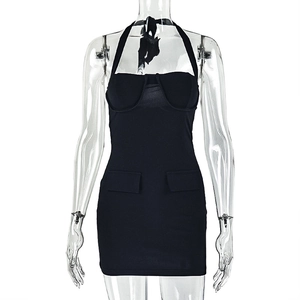Detail of black halter dress featuring slimming elastic fabric and cargo pocket accents