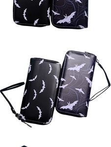 Close-up of Halloween long wallets with bats and spider web patterns and wrist straps