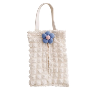 Detail of white bubble texture tissue box with blue floral pattern and hanging strap