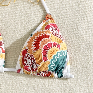 Detailed macro view of floral print bikini top with white drawstring and elastic fabric
