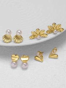 Close-up of pearl earring set featuring heart and floral designs in 18k gold plating