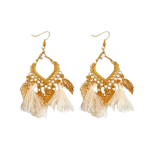 Bohemian gold leaf tassel drop earrings with white cotton fringe on white background