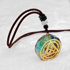 Orgonite energy necklace with colorful natural stones and golden geometric symbol