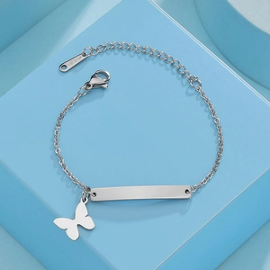 Detailed view of stainless steel kids bracelet with engraved plate and butterfly charm