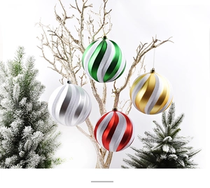 Close-up of 15cm spiral painted Christmas balls in red gold and silver on festive branches