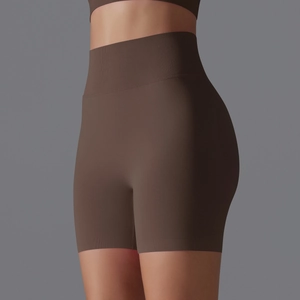 Detail of high-waist seamless compression yoga shorts in dark brown with ribbed texture