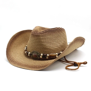 Detail of straw cowboy hat featuring ethnic beaded band and agate stone embellishment