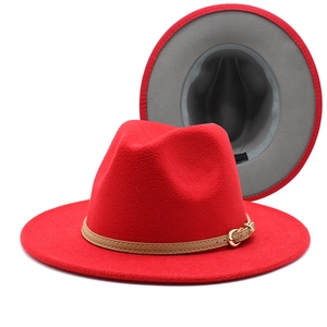 Red wool fedora hat for men and women with brown leather band and gold buckle detail