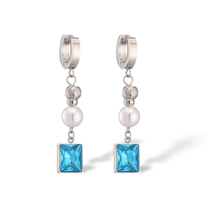 Detail of silver drop earrings with white pearls and blue square crystal pendants