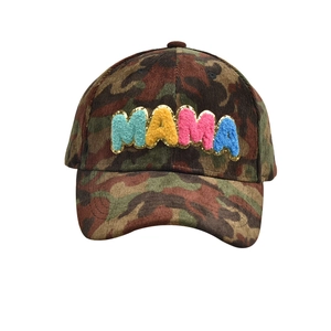 Macro shot of MAMA chenille letters with gold sequins on camouflage baseball cap