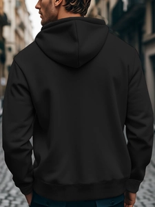 Back view of a black men's oversized cotton hoodie featuring a ribbed hem and casual fit