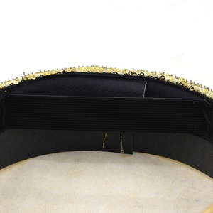 Detailed macro view of gold sequins and black elastic band on the inner hat lining