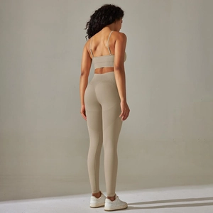 Detail of high waist seamless yoga leggings and racerback sports bra from back view