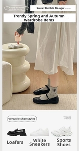 Grey frilly socks with black bow prints paired with loafers and casual sneakers