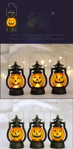 Detail of LED Halloween pumpkin lantern with vintage black handle and warm glow