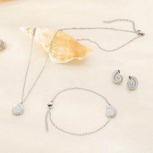 Minimalist silver stainless steel jewelry set featuring conch shell necklace and earrings