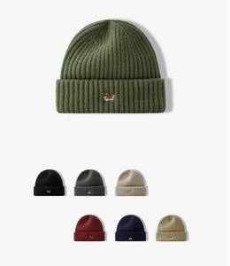 Detailed grid of knitted beanies with cute animal embroidery in multiple colors