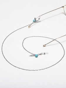 Close-up of stainless steel glasses chain with turquoise beads and feather pendants