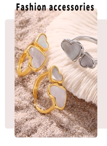 Detailed shot of double heart rings in gold and silver with natural mother of pearl inlay