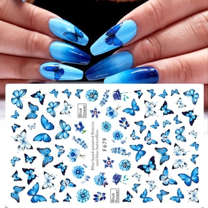 Detail of adhesive nail stickers with blue hand-painted flowers and butterflies