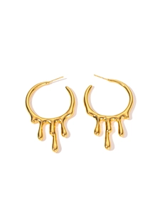 Detailed close-up of golden lava fluid drop earrings with high polish metallic finish