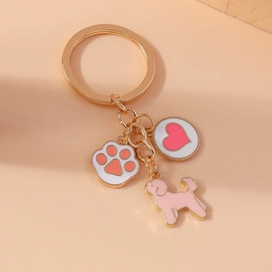 Golden metal keychain featuring cute cat paw, pink dog silhouette, and red heart charm